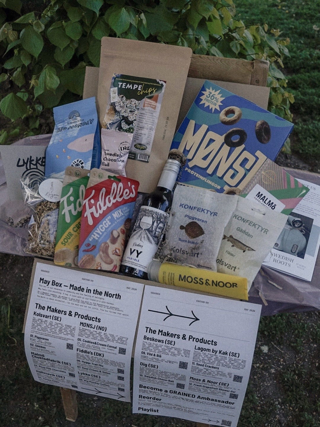 Assorted snack variety from GRAINED's The Monthly Box, featuring a colorful mix of chips, nuts, and crunchy treats in a box.