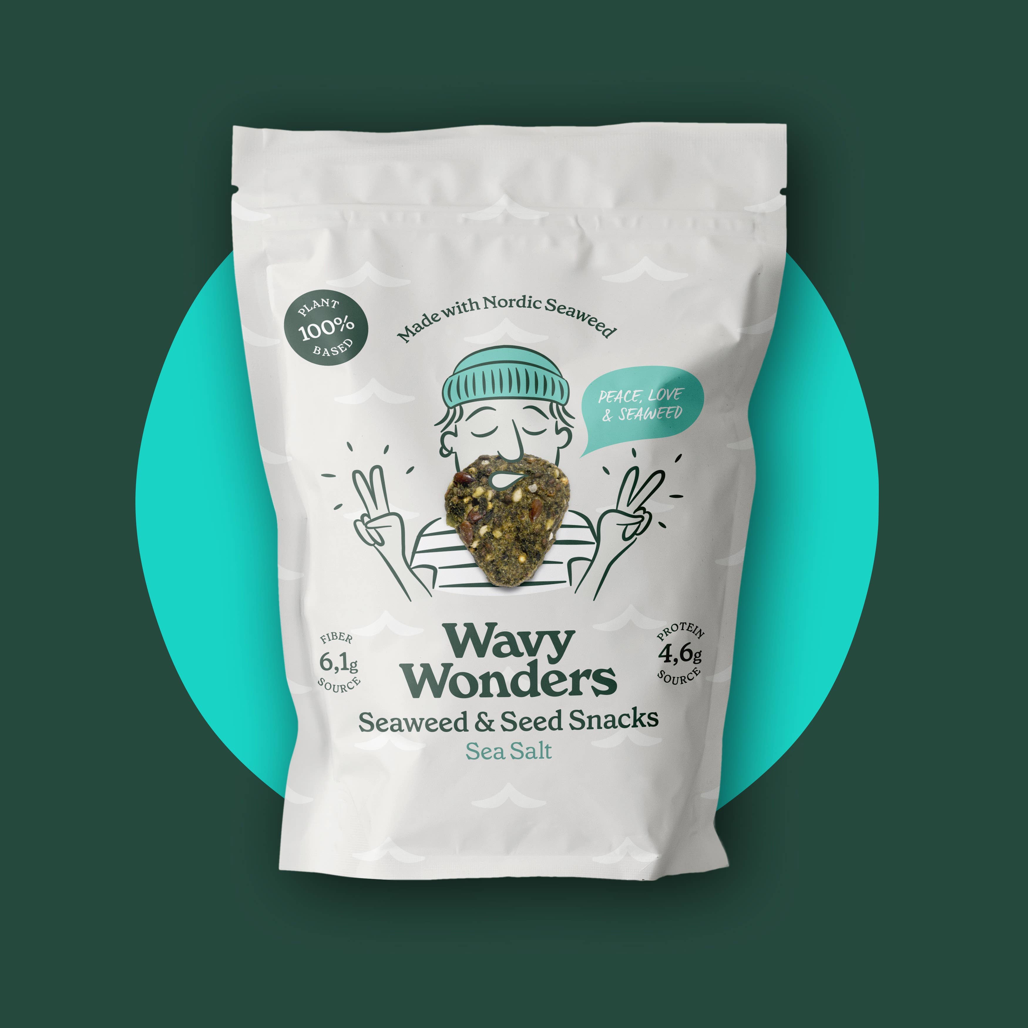 Wavy Wonders seaweed and seed snacks with sea salt, crispy and savory, in bright packaging on a wooden surface.