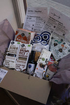 GRAINED The Monthly Box snacks with assorted packaged snack items arranged inside a box.