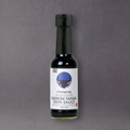 ClearSpring Tamari soy sauce bottle from GRAINED, featuring a dark liquid inside a glass bottle with a white label.
