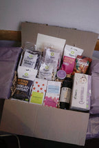 Assorted GRAINED The Monthly Box snack assortment with various chips and treats in colorful packaging.