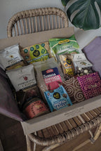 Assorted snack samples from GRAINED's December Monthly Box, featuring a variety of tasty treats in a festive packaging.