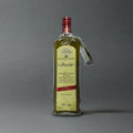 Bottle of Frantoi Cutrera Frescolio Extra Virgin Olive Oil from GRAINED CO., showing the label and olive oil inside.