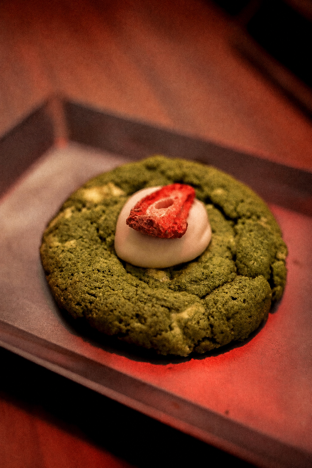 Gluten-free Kristi’s Cookies by GRAINED displayed on a plate with a few cookies on a white background