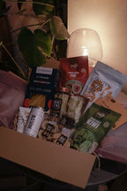 Gluten-free snack box from GRAINED's The Monthly Box featuring a variety of healthy snack options for January.