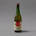 Sparkling apple juice by La Mère Poulard in a clear glass bottle, showcasing golden apple juice with bubbles, from GRAINED CO.
