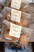 GRAINED Malva's Cookies gourmet Swedish handmade cookies in four flavors, displayed on a rustic wooden surface.