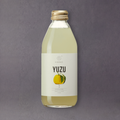 A bottle of GRAINED CO. Kimino Yuzu Soda with a vibrant label featuring yuzu fruit and Japanese-inspired design.