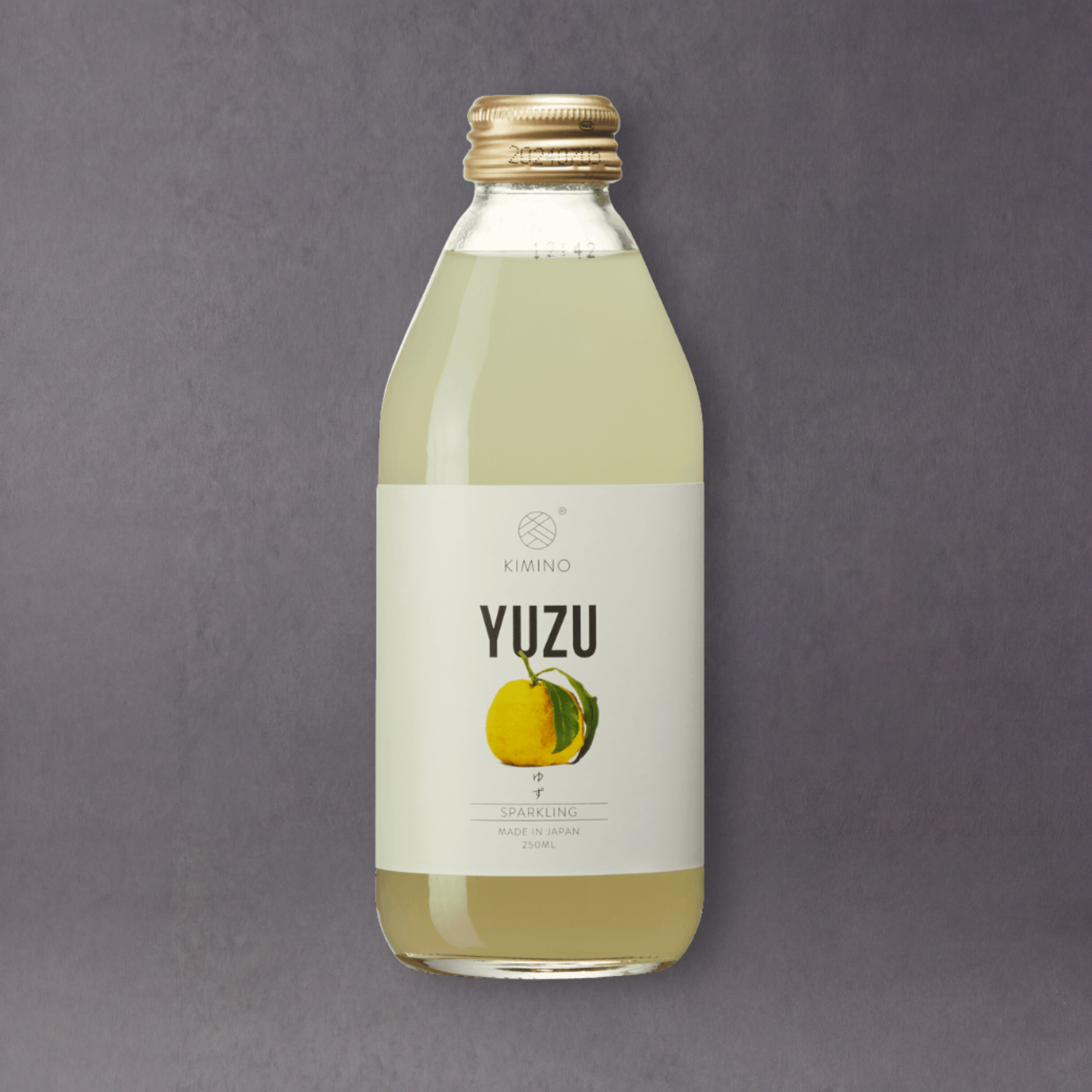 A bottle of GRAINED CO. Kimino Yuzu Soda with a vibrant label featuring yuzu fruit and Japanese-inspired design.