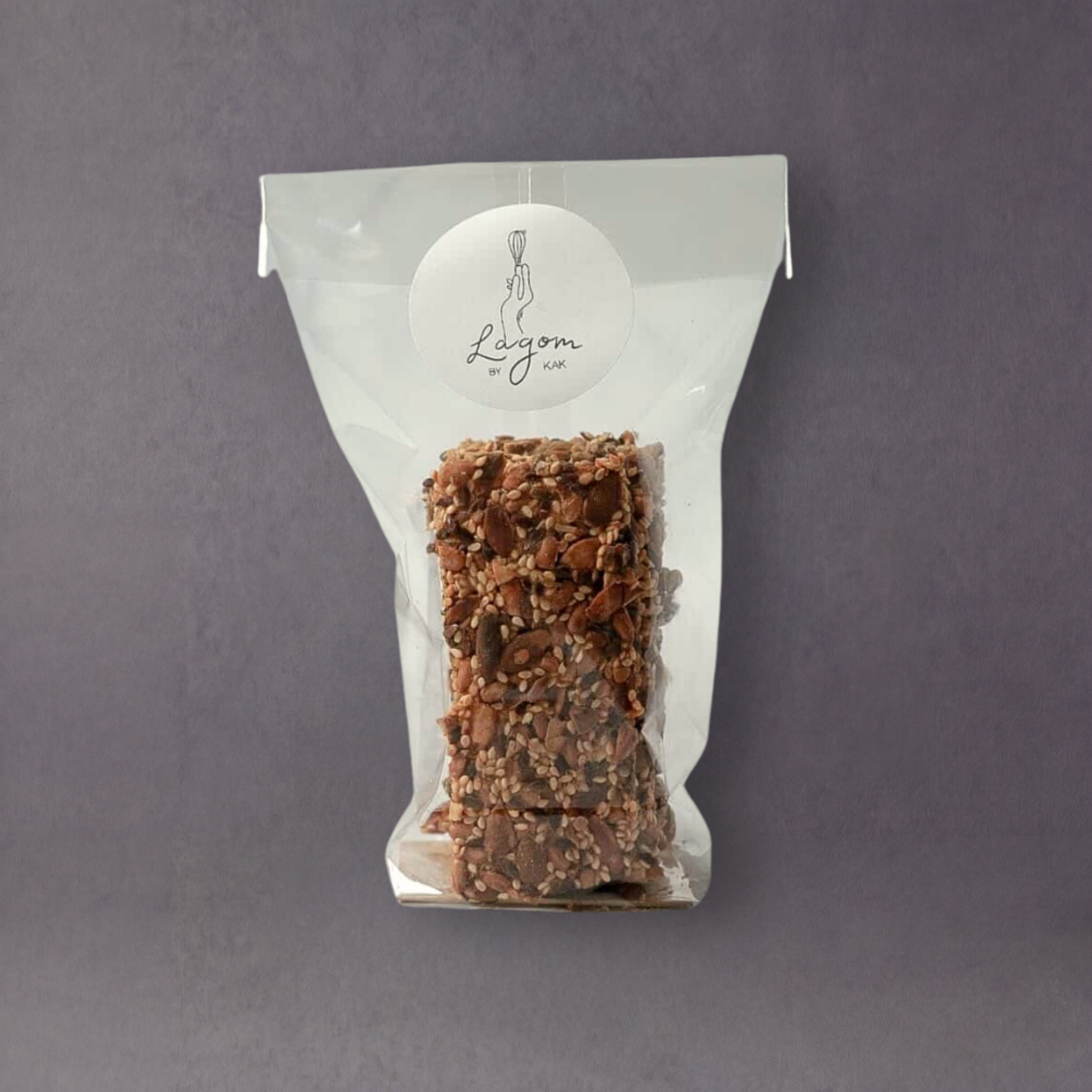 Lagom by Kak Seed Crackers, gluten-free Swedish crackers with visible seeds, displayed on a wooden surface.